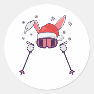 Sticker Rond Lapin de Noël skieur avec chapeau de Père Noël et