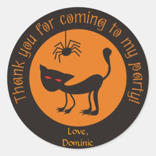 Sticker Rond Le chat noir avec le rouge observe des