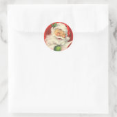 Sticker Rond Le Père Noël avec un clin d'oeil (Sac)