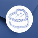 Sticker Rond Mariage Whimsical Vintage Gâteau Levé main<br><div class="desc">Stickers Monogramme Mariage de gâteaux Vintages personnalisés. Ces autocollants de mariage ronds personnalisés présentent au centre une simple illustration de gâteau de style vintage, agrémentés d’élégants détails bleus et surmontés des initiales monogrammes du couple et de la date du mariage pour une touche intemporelle et sophistiquée. Le design minimaliste présente...</div>