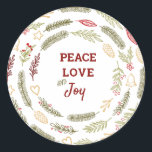 Sticker Rond Peace Love Joy Simple Rustic Christmas Foliage<br><div class="desc">Parfaits pour l'emballage cadeau ou les scellés d'enveloppe, ces autocollants ont un design rustique simple du feuillage de Noël. Le texte du centre dit "Peace love and Joy" et est encadré de cercles de pins, de branches de sapins, d'ornements de Noël, de saints, de mistletoe et de baies d'hiver. Des...</div>