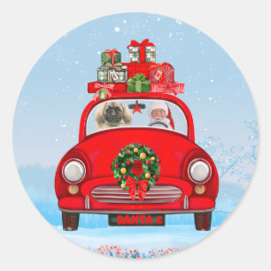 Sticker Rond Pékinois en voiture avec le Père Noël