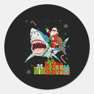 Sticker Rond Père Noël à cheval sur un requin pyjama de Noël mi