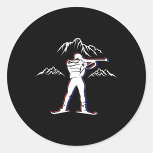 Sticker Rond Un biathlète avec fusil et skis de fond Moti