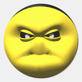 Sticker Rond Un visage jaune en colère.