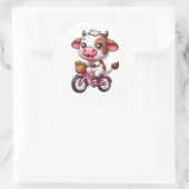 Sticker Rond Vache marron et blanche à vélo (Sac)