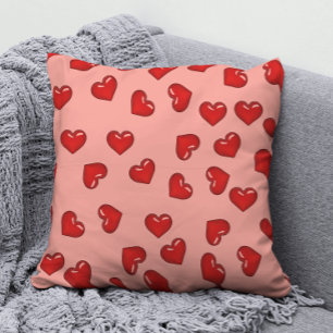 Stijlvol rood hartenpatroon op roze kussen