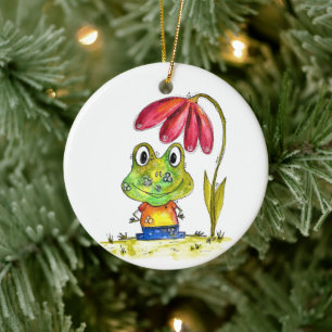 Stomme witte groene kikker onder een rode ventilat keramisch ornament
