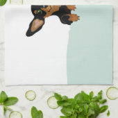 Superschattige dachshundpupil onder groen dekbed theedoek (Gevouwen)