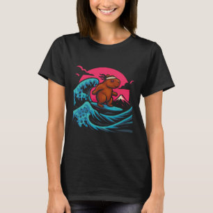 T-shirt Capyra surfe sur les vagues sous un ciel rose T-sh