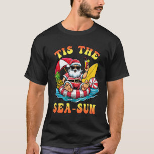 T-shirt C'est le soleil de mer du Père Noël surfant Noël e