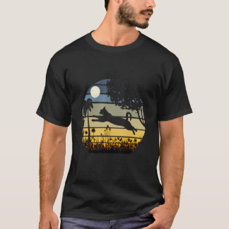 T-shirt Chat sautant dans un champ de fleurs nuit de lune