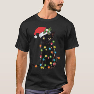 T-shirt Le Chat Noir De Père Noël Enveloppé Dans Les Lumiè