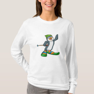 T-shirt Pingouin comme skieur avec ski et Casquette