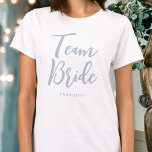 T-shirt Team Bride Mariage personnalisé Dusty Blue<br><div class="desc">Célébrez votre équipe de mariées avec ce t-shirt mariage personnalisé ! Les mots 'Team Bride' sont écrits dans une police de script tendance, et ci-dessous vous pouvez ajouter un nom personnalisé, une date mariage, un emplacement ou un autre texte. Un beau cadeau pour une soirée bachelorette, un wedding shower ou...</div>