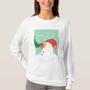 T-shirt Un bonhomme de neige accrochant un ornement sur un