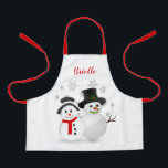 Tablier Cute Christmas Snowman Personnalisé<br><div class="desc">Ce petit tablier de Noël a été créé pour que les enfants et les filles puissent s'habiller pour faire cuire des biscuits de vacances, peindre ou jouer pendant toute la saison hivernale. Le design comprend un joli design de bonhomme de neige de Noël avec un arrière - plan de flocons...</div>