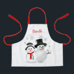 Tablier Cute Christmas Snowman Personnalisé<br><div class="desc">Ce petit tablier de Noël a été créé pour que les enfants et les filles puissent s'habiller pour faire cuire des biscuits de vacances, peindre ou jouer pendant toute la saison hivernale. Le design comprend un joli design de bonhomme de neige de Noël avec un arrière - plan de flocons...</div>