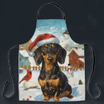 Tablier Dachshund Winter Wonderland Christmas Joy<br><div class="desc">Ce design festif reflète l'esprit joyeux de la période des fêtes, avec un adorable petit portant un chapeau de Père Noël. Le chien est niché dans un pays des merveilles hivernales, avec un bonhomme de neige, un sapin de Noël décoré et des cadeaux joliment emballés. Les flocons de neige tombent...</div>