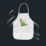 Tablier Enfant Cute Christmas Dinosaur Santa Custom<br><div class="desc">Cool green dinosaur looking very cute in a holiday red Santa hat with a little smile on an adorable childrens apron. I like fun Christmas animals and presents that kids will love. Customize this gift with the child's name to make it even more personalized.</div>