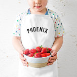 Tablier Enfant Nom personnalisé Monogramme | Black<br><div class="desc">Ces tabliers personnalisés arborent le nom de votre enfant dans une police voûtée moderne, ce qui les rend parfaits pour les jeunes chefs qui aident dans la cuisine, les habillement créatifs ou comme des fumettes d'artiste pour protéger les vêtements pendant l'artisanat. Fabriqués en tissu durable et facile à nettoyer, ces...</div>