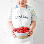 Tablier Enfant Nom personnalisé Monogramme | Marine<br><div class="desc">Ces tabliers personnalisés arborent le nom de votre enfant dans une police voûtée moderne, ce qui les rend parfaits pour les jeunes chefs qui aident dans la cuisine, les habillement créatifs ou comme des fumettes d'artiste pour protéger les vêtements pendant l'artisanat. Fabriqués en tissu durable et facile à nettoyer, ces...</div>