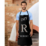 Tablier Monogramme et nom personnalisés noir et blanc<br><div class="desc">Ce tablier design unique pour votre chef est doté d'un monogramme en trois couleurs — regardez attentivement et vous verrez par vous-même. C'est contre un arrière - plan noir. Pour toute question de conception,  envoyez un courriel à charmdesignstudio@rcn.com et nous serons ravis de vous aider.</div>