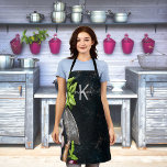 Tablier Monogramme rustique légumes herbes<br><div class="desc">Nourriture fraîche, herbes, oignons de basilic, herbivores sur la toile rustique foncée d'un peintre aux taches de peinture. Personnalisez et ajoutez votre initiale monogramme, nom. Le nom est écrit avec un script de style moderne écrit à la main avec des swashes. Pour que les swashes ne suppriment que le nom...</div>