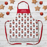 Tablier Motif Nutcracker Red Christmas<br><div class="desc">Un simple motif de noix de Noël rouge,  noir et argent décore cet tablier. Fait un cadeau de Noël amusant. Personnalisez-le avec votre nom cette saison de Noël. Conçu pour vous par Blackberry Boulevard.</div>