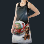 Tablier Winter Dachshund Caravan Christmas Adventure<br><div class="desc">Laissez-vous tenter par la magie d'une nuit d'hiver enneigée alors qu'une caravane glisse gracieusement à travers le paysage illuminé par la lune. La beauté sereine de la neige scintillante et l'éclat enchanteur de la lune créent une scène captivante, promettant une aventure de Noël inoubliable remplie de chaleur, de joie et...</div>