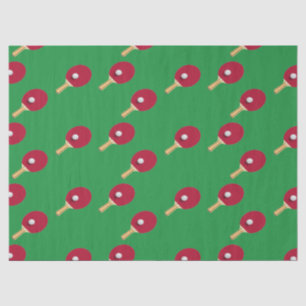 Tafeltennisracket en bal op groen tissuepapier