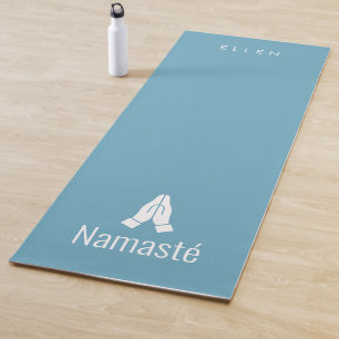 Tapis de yoga bleu avec Namasté mains ensemble icô