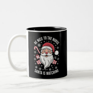 Tasse 2 Couleurs Soyez gentil avec l'infirmière Santa regarde Noël