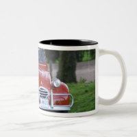 Une vieille voiture rouge Citroen 2CV avec une fem