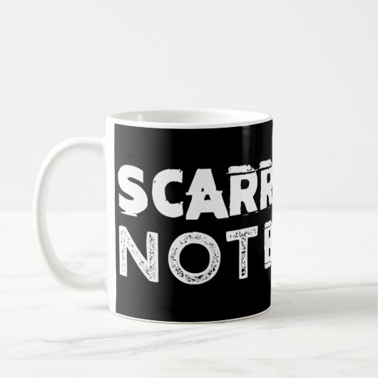 Tasse de café noir marquée mais non cassée (Gauche)