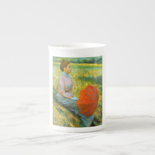 Tasse En Porcelaine Dame reposant dans une prairie verte