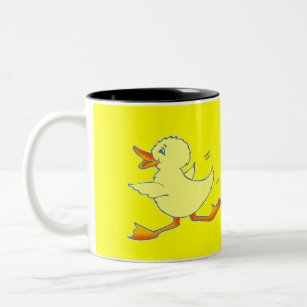 Tasse jaune lumineuse de canard de Quackers