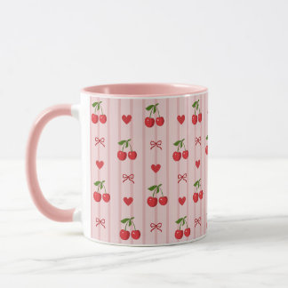 Tasse rose avec cerises rouges et noeuds et coeurs