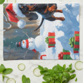 Teckel loopt in de sneeuw met kerst Pet Theedoek (Gevouwen)