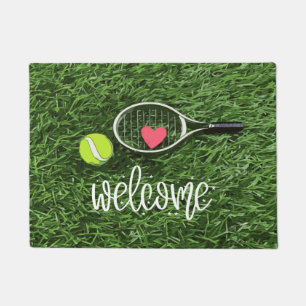 Tennisbal en racket op groen welkom deurmat