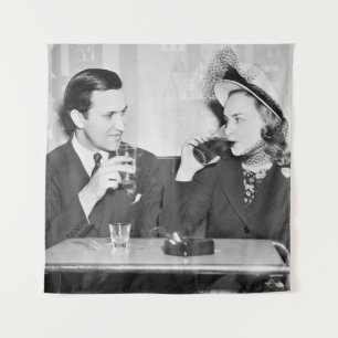 Tenture Couple sitting together in a restaurant flirting w