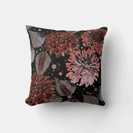 Terracotta bloemen met grijze bladeren op een zwar kussen