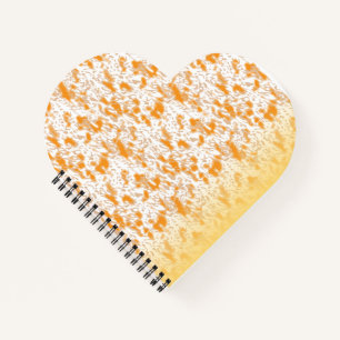 Textielpatroon met een levendig sinaasappel en gou notitieboek