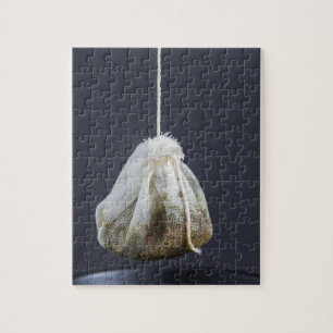 Theezakje hangt in een kopje legpuzzel