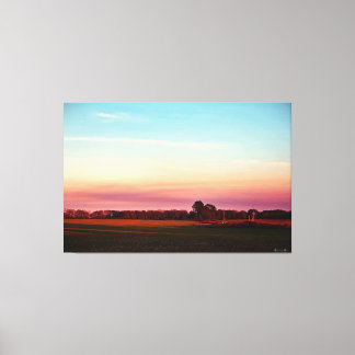 Toile Coucher de soleil sur un champ verdoyant