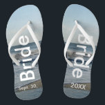 Tongs Bride Ocean Waves Beach Sand<br><div class="desc">Joli Ciel Bleu avec des nuages Blancs clairs, Mer Bleue, Vagues d'Océan et Sable de Plage. Unisex Flip Flops with Bride and Date of Marriage écrit dans un texte blanc. PERSONNALISER avec votre DATE Mariage (ou supprimer du texte). La date du mariage est écrite dans le sable. Choisissez des sangles...</div>