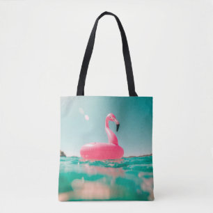 Tote Bag Bague de baignade rose flamingo sur le plan d'eau