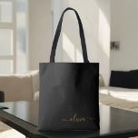 Tote Bag Black Name Gold Girl Script Monogramme moderne<br><div class="desc">Black and Gold Elegant Ajoutez votre propre nom Monogram Book Bag. Ce sac de livre peut être customisé pour inclure votre nom initial et prénom et donné comme cadeau pour Noël,  Sweet 16 Anniversaire,  Fête des mariées ou Mariage.</div>