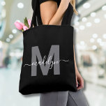 Tote Bag Black Trendy Modern Script Name Monogram<br><div class="desc">Personalized Elegant Black Trendy Modern Script Name Monogram Tote Bag. Add a touch of sophistication to your everyday style with this chic tote bag. Featuring a sleek gray initial centered on a crisp black background, with a clean and modern design on both sides, this tote combines elegance with practicality. Perfect...</div>