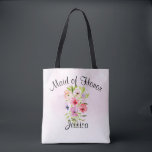 Tote Bag Bouquet de fleurs d'aquarelle Maid of Honor Mariag<br><div class="desc">Ce joli fourre-tout est le sac à bagages parfait pour remercier votre bonne d'honneur pour son travail acharné qui rend votre jour de mariage spécial. Il présente un beau bouquet d'aquarelle de fleurs sauvages, de pansies ou de violets sur un arrière - plan rose pâle. La légende en haut dit...</div>